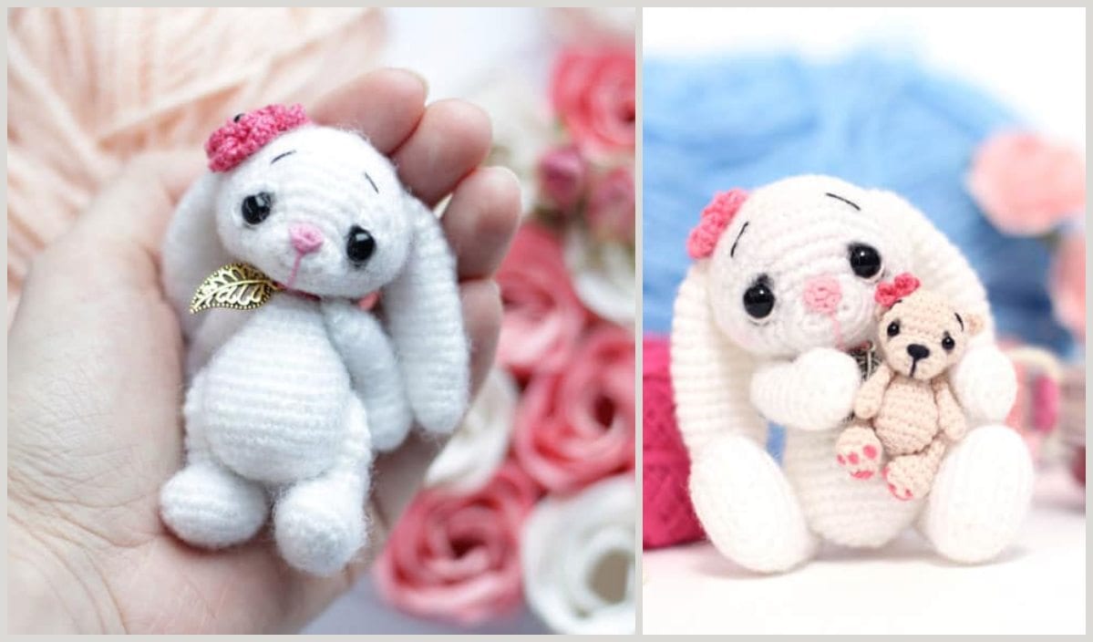 A hand cradles a small crocheted white bunny adorned with a pink flower and a gold leaf charm, perfect for Easter. Beside it, the bunny holds an adorable tiny bear. Pink and blue yarn complete this enchanting scene.
