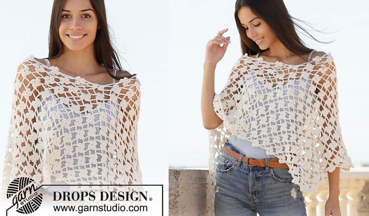 A woman wearing the enchanting Sweet Jasmine Poncho with a geometric pattern poses outdoors, showcasing the Garnstudio label.
